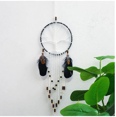 Attrape Rêve Arbre de Vie Eden Atelier Macramé sur un mur blanc