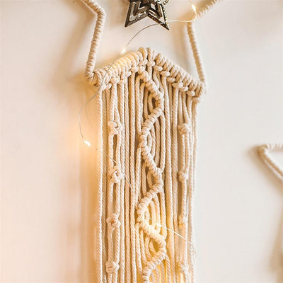 Attrape rêve en Macrame Izar provenant de la boutique Atelier Macrame avec une guirlande lumineuse